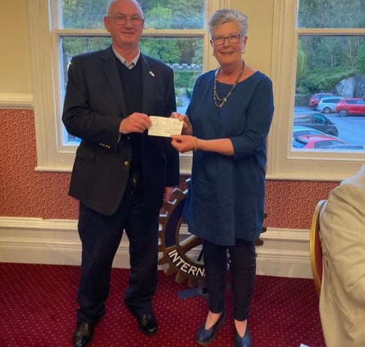 Club President Nigel Ellis presenting Joy Harrison with a cheque for £1,500