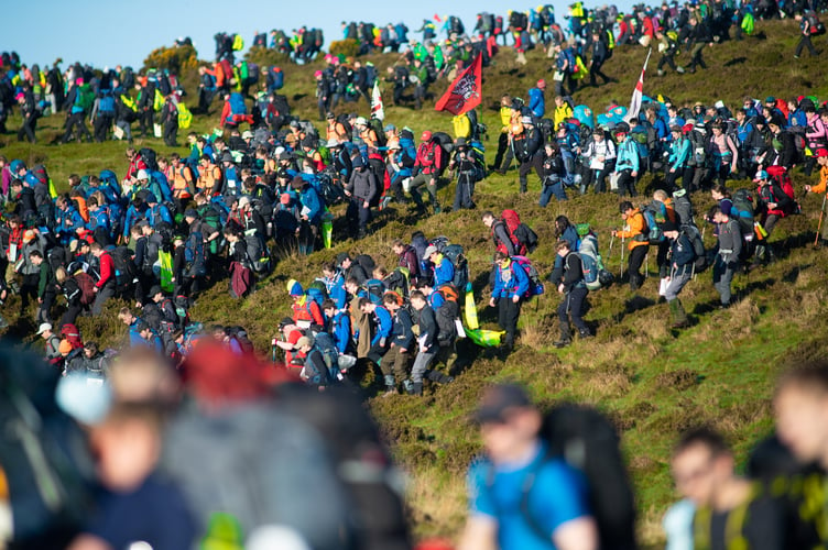 Pictured;

The mass start of Ten Tors 2019 as they walk down a very steep hill.

TEN TORS AND JUBILEE CHALLENGE (EXERCISE WYVERN TOR) 2019  

As well as a vital high-level military resilience exercise - called Exercise WYVERN TOR - The Ten Tors Challenge is also one of the biggest outdoors adventure events for young people in Britain today. In all, 2400 youngsters aged between 14 and 19 will take part in Ten Tors, with a further 300 youngsters with physical or educational needs taking part in the Jubilee Challenge.
The majority of the teams who enter Ten Tors are from schools and youth groups from across the South West. These include scout groups, sports and ramblersÕ teams and Armed Forces cadet units, all of whom have trained hard over the last few months and are ready to accept the challenge!
Those teenagers taking part will trek unaided over different 35, 45 or 55 mile routes and will encounter some of the toughest terrain and highest peaks in Southern England. They will rely on their navigational skills and will carry all their food, water, bedding, tents and other essentials as they go. It is a feat they must complete as a team and without any help from adults and theyÕll remain entirely self-sufficient during their arduous expeditions, including camping out overnight on the moor.


One of the most enduring legacies of Ten Tors is a lasting appreciation of the beauty of Dartmoor which is instilled in every young person taking part. For some it may be the first time they have spent any length of time walking in the countryside. For many it is sure to ignite a passion for the outdoors which stays with them forever. But for all it is something theyÕll never forget, and team managers are guided to encourage participants to develop respect and appreciation for the landscape, cultural heritage and wildlife of Dartmoor.

Photographer:
CPL BEN BECKETT RLC /MoD Crown Copyright