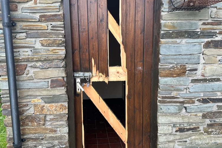 Damage that occurred to the cemetery toilet door.