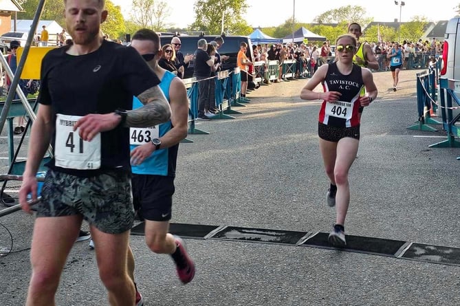 Tavistock Athletic Club's Charlotte Walker crossing the finish line at the Ivybridge 10k