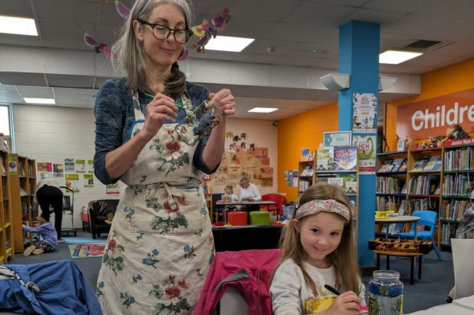 Children learning how to paint glass in Tavistock Library for national Big Green Week, marking action to tackle climate change and protect nature.