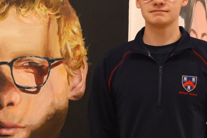 Kelly College art student Sam with his self-portrait at the  end-of-year public exhibition at the college. 