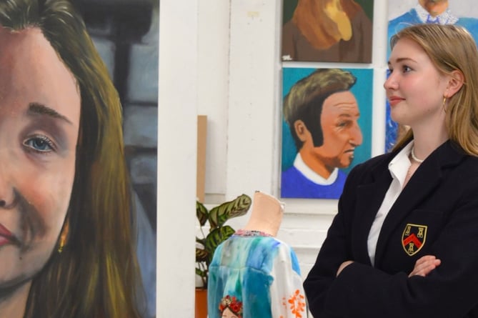 Mount Kelly College art student Phoebe with her A-Level self-portrait on public show at the school..