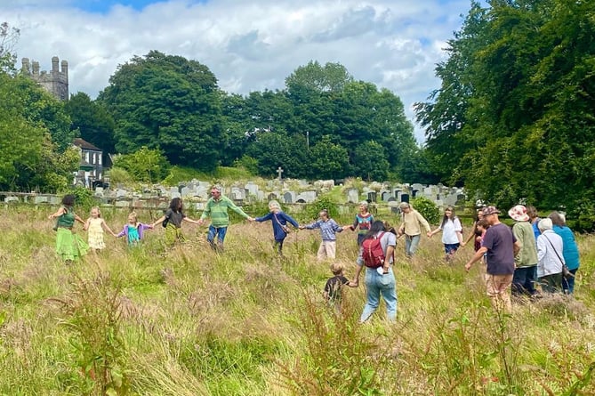 Linking hands in the meadow beside the church.