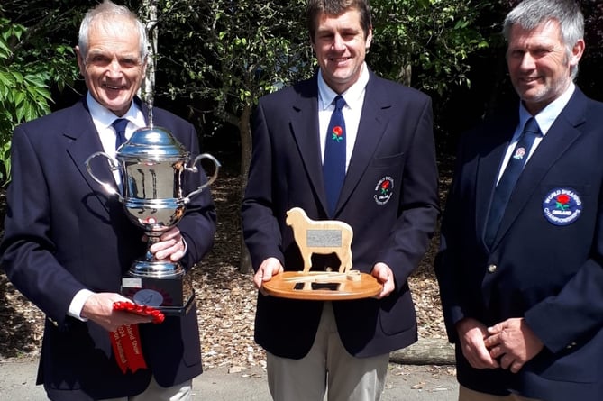 George Mudge and son Andrew with another sheep shearing trophy.