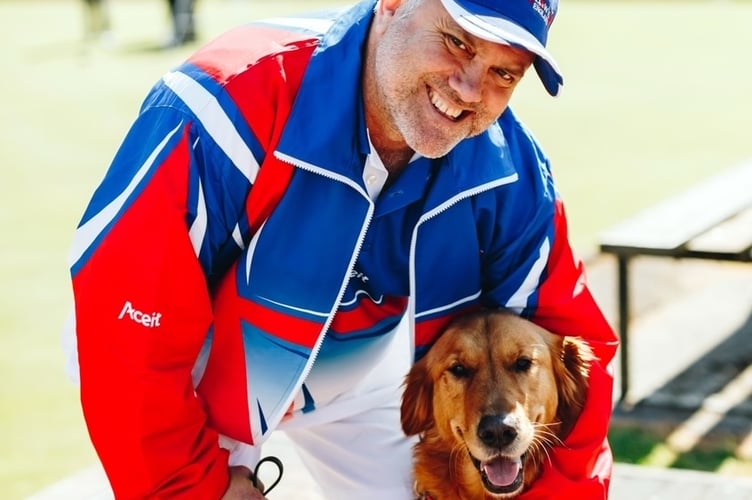 Stephen Hartley, pictured with his guide dog at Tavistock Bowls Club, has won a national team silver medal. 