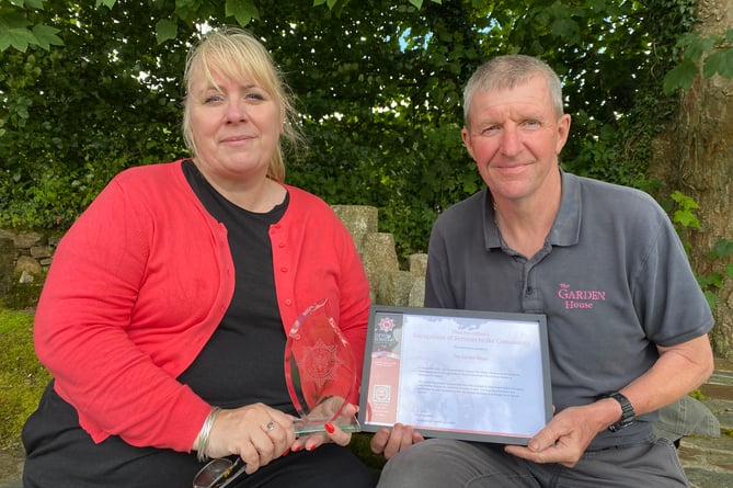 Maria Outram, Garden House operations manager, with a fire service award for allowing gardener David Milburn to be on duty as a part time fire fighter at Yelverton.