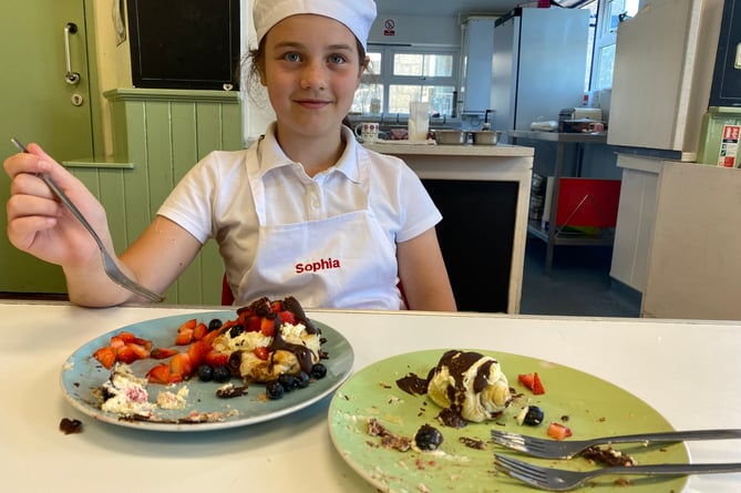 Sophia with her cream and chocolate master bake at Princetown School bake-off.