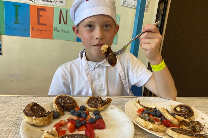 Benji tasting his cinnamon swirls at Princetown School bake-off.