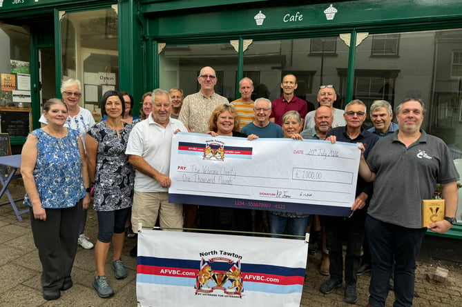 The Veterans Charity representatives, case worker Paul Howard, in white shirt and Danny Greeno, chief executive, right, receiving the cheque from Armed Forces Veterans Breakfast Club North Tawton.  AQ 7825
