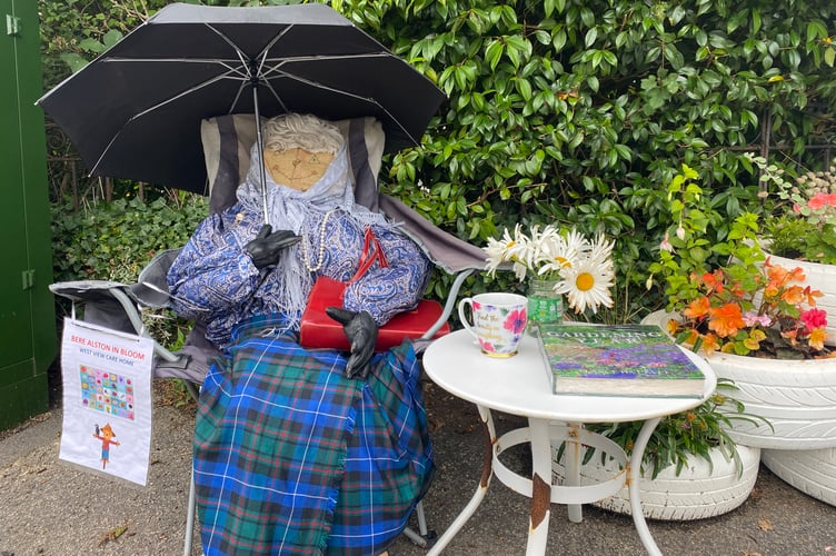 West View Care Home's entry into the Bere in Bloom competition - a seated lady with umbrella.