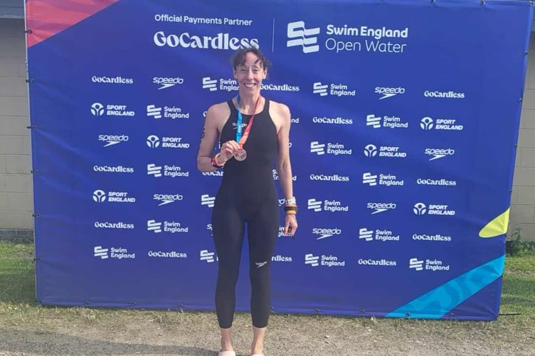 Sam Lake, of Tavistock Swimming Club, celebrating a medal at the National Open Water Masters Championships.