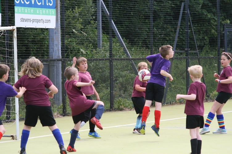 Heading clear at West Devon Primsry Schools Mixed Football Tournament