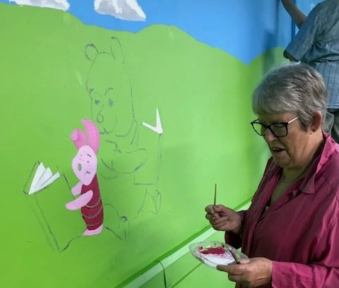 Jane Jenny painting piglet in the Atlantic Rainforest Library at Bere Alston Primary Academy