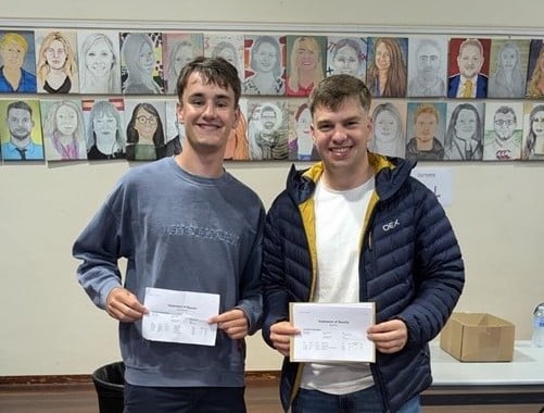 Students Sam Boyle and Joel Blake collecting their results