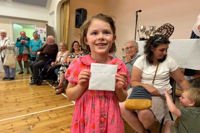 A young prizewinner with her prize.  AQ 1071