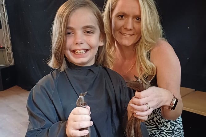 Amelia Trapp, eight, with her hairdresser Emilie Welch and her hair