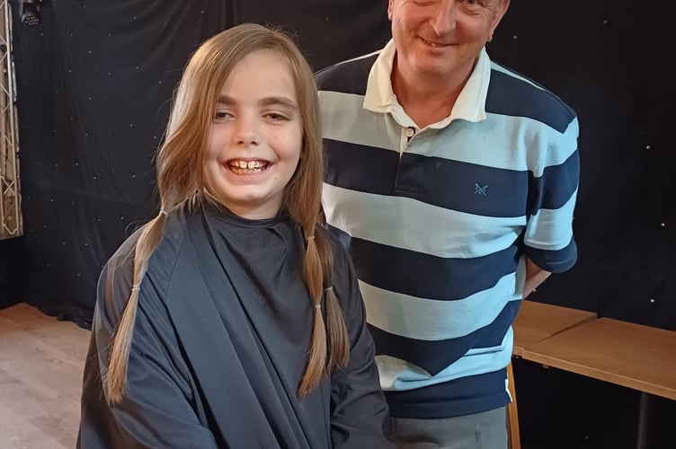 Amelia, eight, before her haircut with The Riffle Volunteer landlord Paul Tarplee