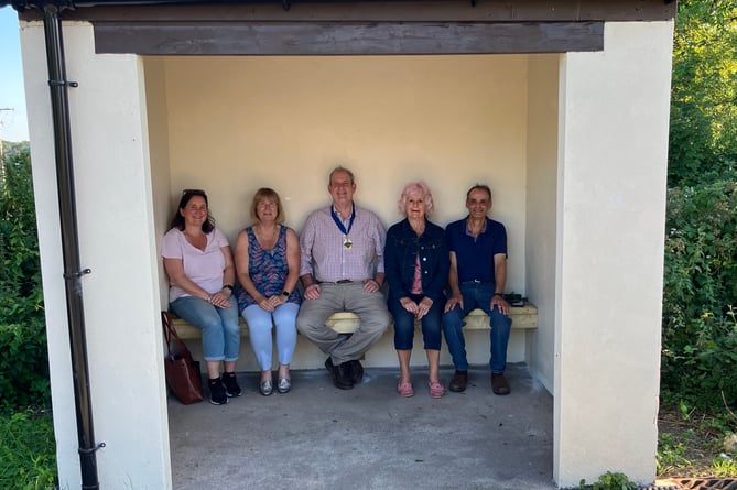 Plasterdown Parish Council members in the revamped bus shelter at Grenofen