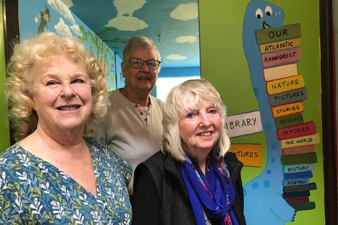 At the entrance to the magical library at Bere Alston Primary are, from left, Dr Frances Howard, Anne Crozier, back, and Angela Hooper