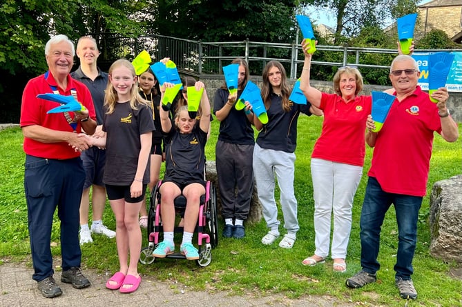 The Tavistock Lions with young swimmers at Tavistock Swimming Club - their donations has paid for fabulous fins to help swimmers learn the basics in the pool