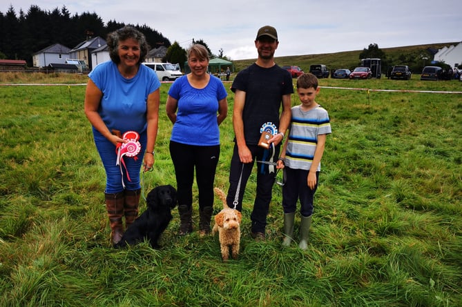 Dog show winners from left: Amanda Ewels with Denzel, Judge Janice Locke and Richard and Isaac Wain – ‘a delightful young man who worked hard to encourage Doris to show herself off well’ according to Janice!’ 