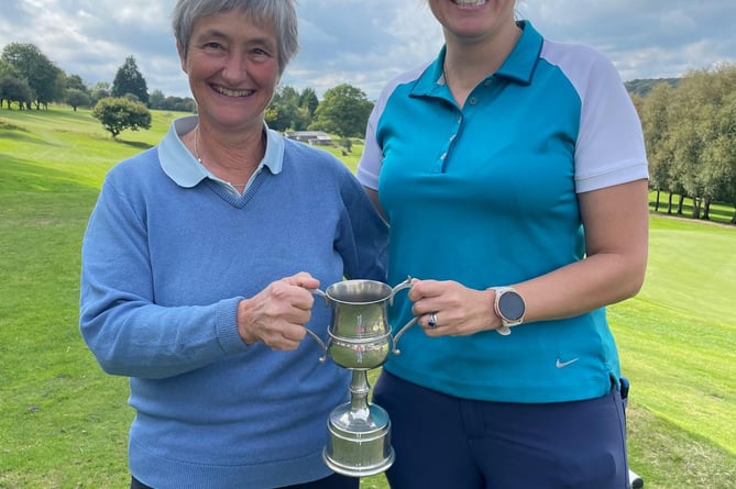 Sue Williams (left) presents the trophy to club champion Abby Turner