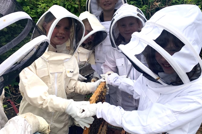 Mount Kelly College pupils all dressed up to collect the honey from their hives.