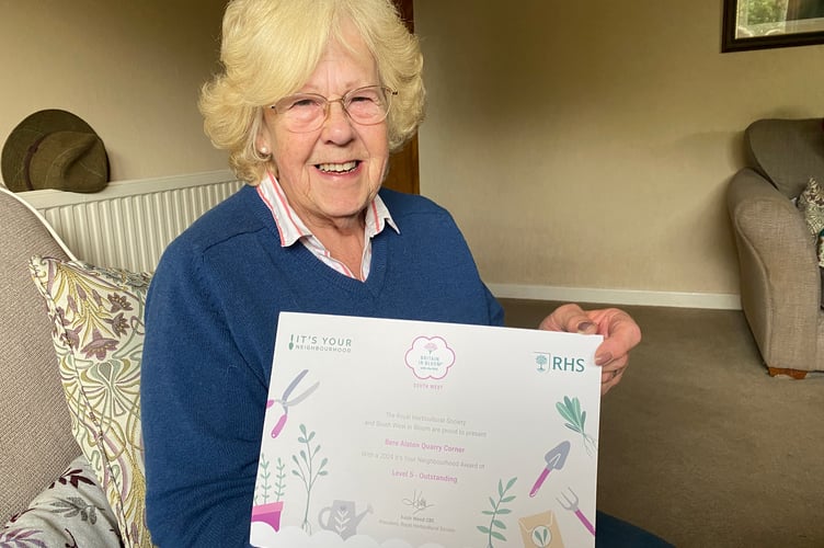 Bere Alston In Bloom team deputy chair Liz McQueen with her Britain in Bloom SW 'outstanding' award for creating Quarry Corner flower bed.