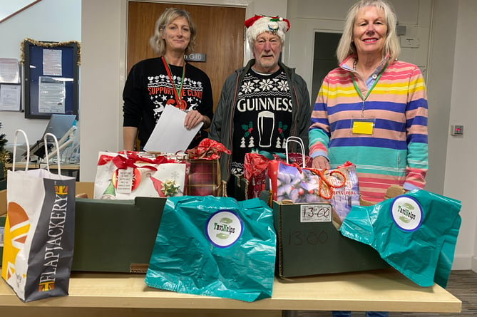 The TaviHelps charity is asking for volunteers (pictured helping out last year with Judy Hirst far right) to help pack and wrap Christmas treats for delivering to Tavistock doorsteps this year.