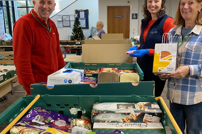 Generous residents packing Christmas food and treats for needy Tavistock householders last year.