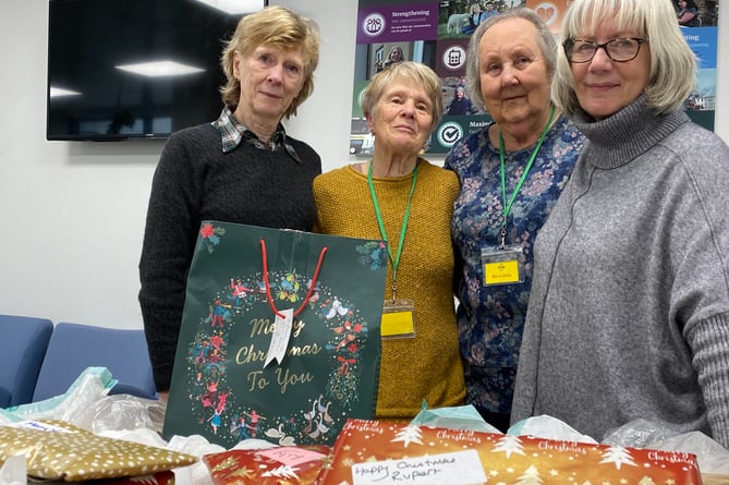 Volunteers packing Christmas treats last year for TaviHelps to deliver to needy households. 