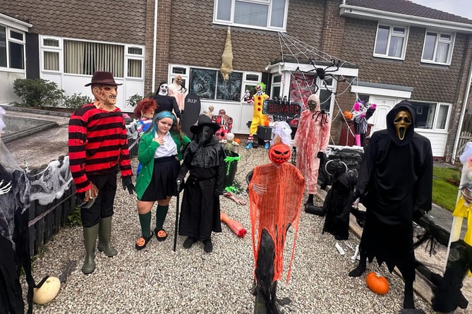 Melody Vallis, 14, joins the cast of Halloween characters dressed as a character from the musical Heathers outside her Bere Alston home.