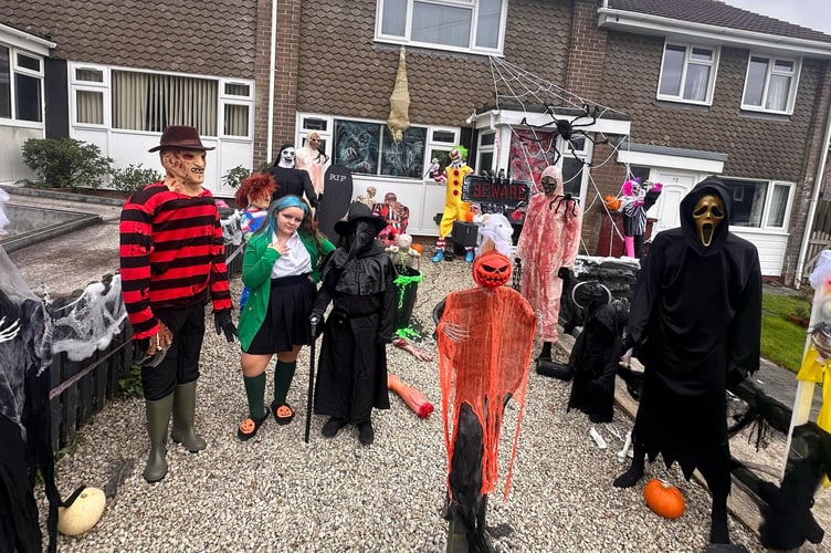 Melody Vallis, 14, joins the cast of Halloween characters dressed as a character from the musical Heathers outside her Bere Alston home.