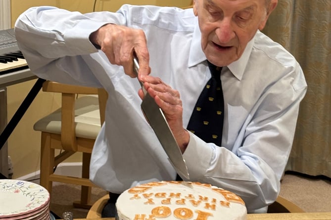 Edward cutting his cake