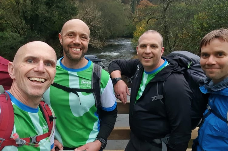 Trekking friends from left Nige Locke, Steve Andrews, Steve Payne and Lee Wickett crossing a river on their charity trek.