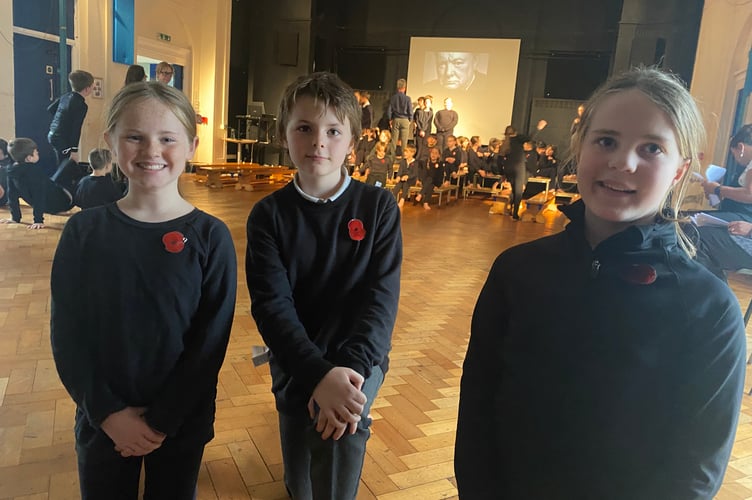 Martha, Matthew, and Rowan take a break from rehearsing the Remembrance song Churchill's Road at Tavistock Primary School.