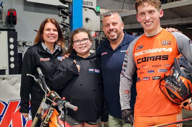 Farrah, Kelsey and Mark Tillyer of TyreMarks with trail biking champion Billy Green, right, after his display at the garage