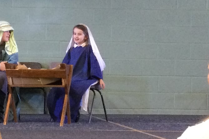 Bere Alston School Nativity play with Mary and Joseph playing to proud parents.