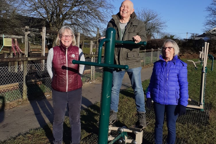 Bere Ferrers Parish Cllr Colin Shaw shows off one of the new fitness machines on Bere Alston Rec to his wife Carolyn and Cllr Virginia Grouse