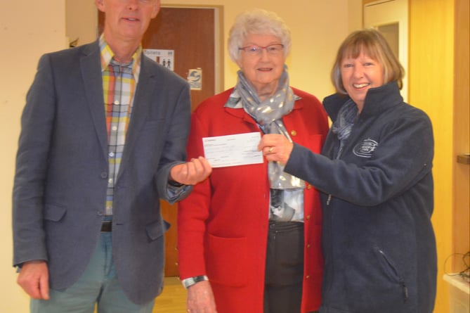 Tavistock's Sir Francis Drake Bowling Club chair Sue Silcox (centre) presents funds to Graham Coiley and Heather Rayne of Tavistock Memory Cafe.