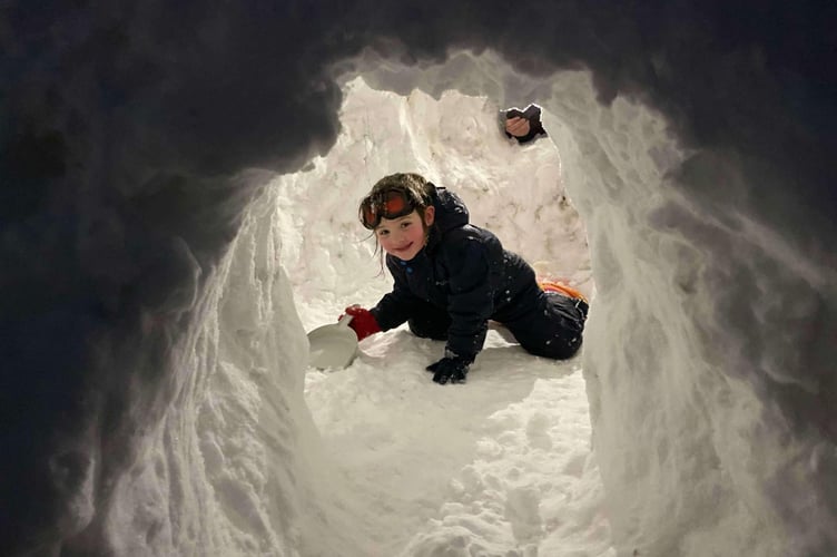 An igloo takes shape in Princetown made by Rose Wildgoose and other children and designed by a Marine.