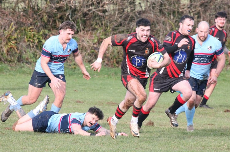 Tavistock's Ethan Lamerton leaves the defender for dead