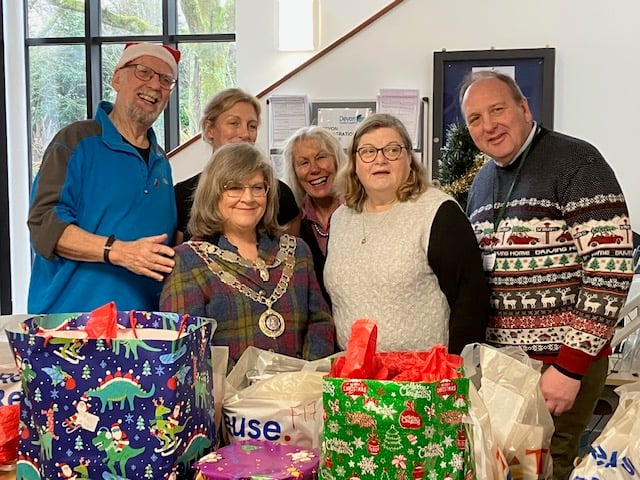 Graham Parker, left, and volunteers at Tavi Helps Christmas Treats bag filling station. 