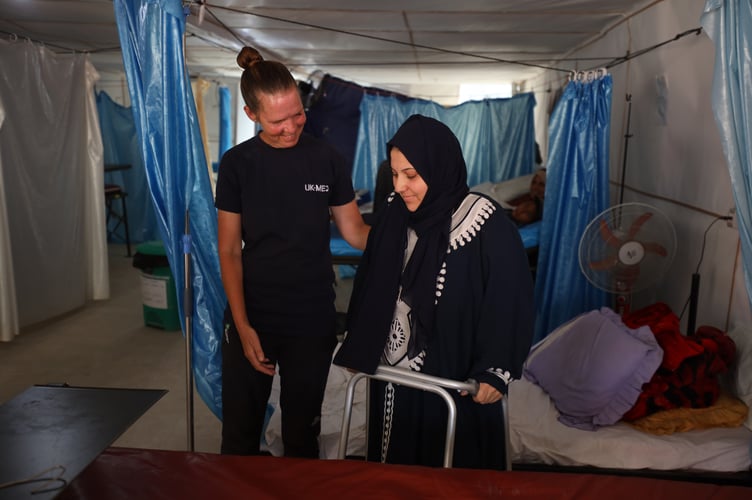 Nurse Paula Tobin with a patient in an emergency field hospital in Gaza. She received a new Humanitarian Medal from the King for her work.