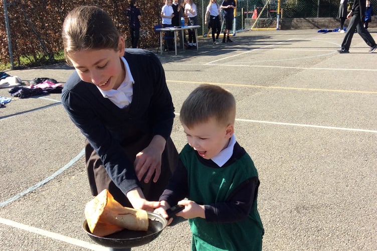 Whitchurch School children getting the hang of running and flipping pancakes. 