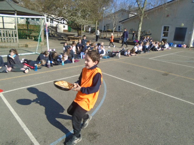 Racing to the finish of the pancake race at Whitchurch School.