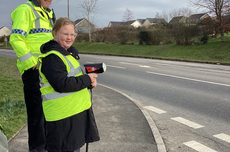 Police and volunteers conducting a speed monitoring session on the Crediton Road outside St James' Primary School.