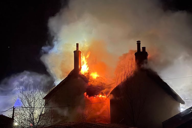 Firecrews at the scene of the thatched property fire in Drewsteignton.
Photo:  The Drewe Arms Community Pub/Facebook