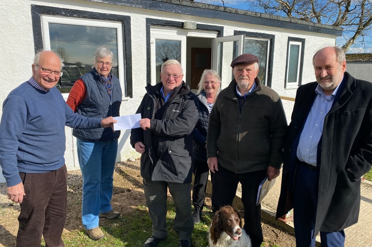 Parish Council chairman Cllr Peter Crozier receives a donation towards the design of the planned new Bere Alston sports pavilion